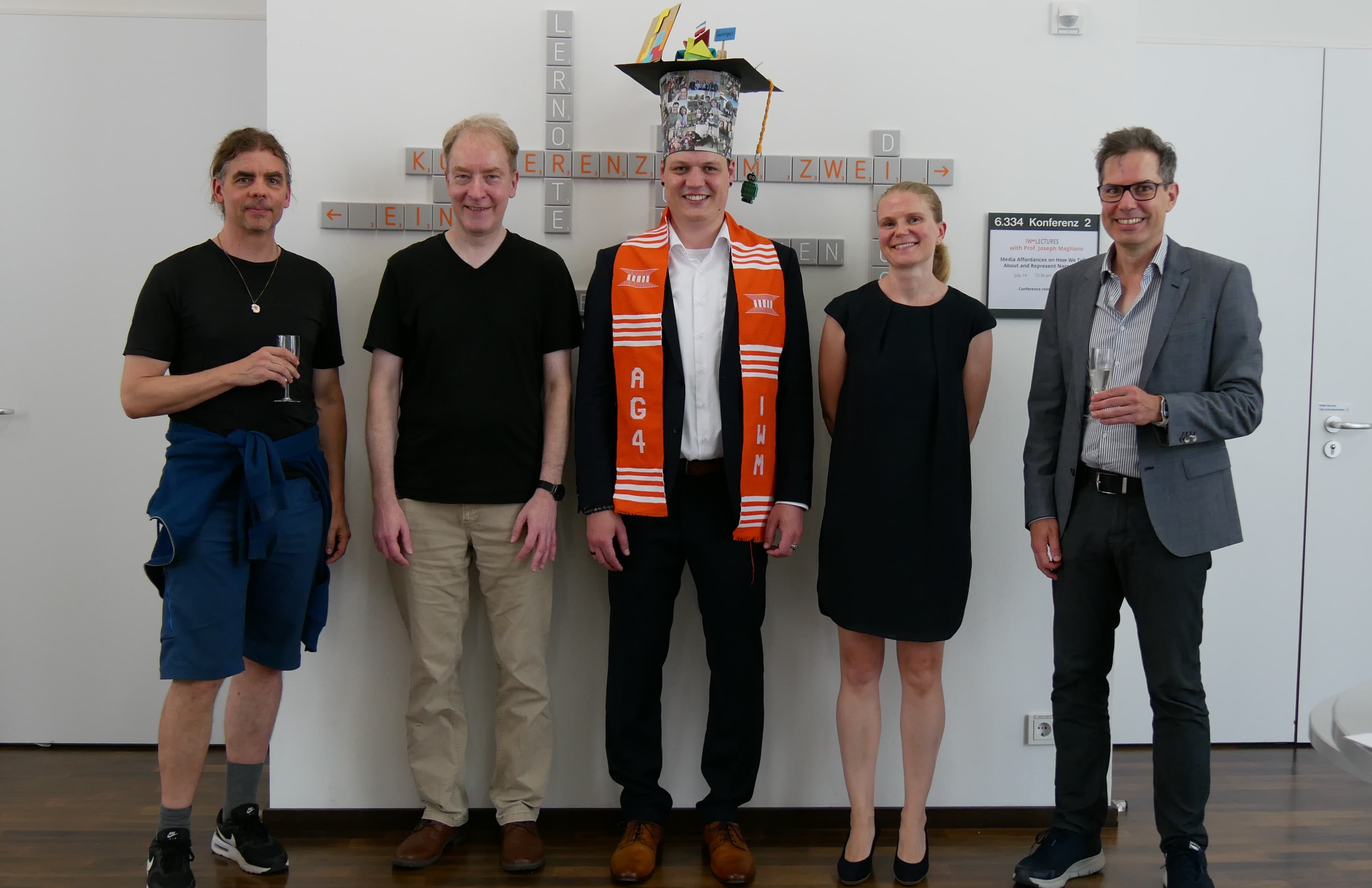 ChatGPT: Dr. Fritz Becker with four other people at the defense of his dissertation