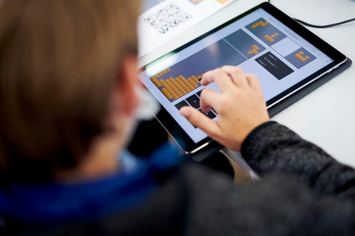 A person operating a tablet during the Science Day at the IWM