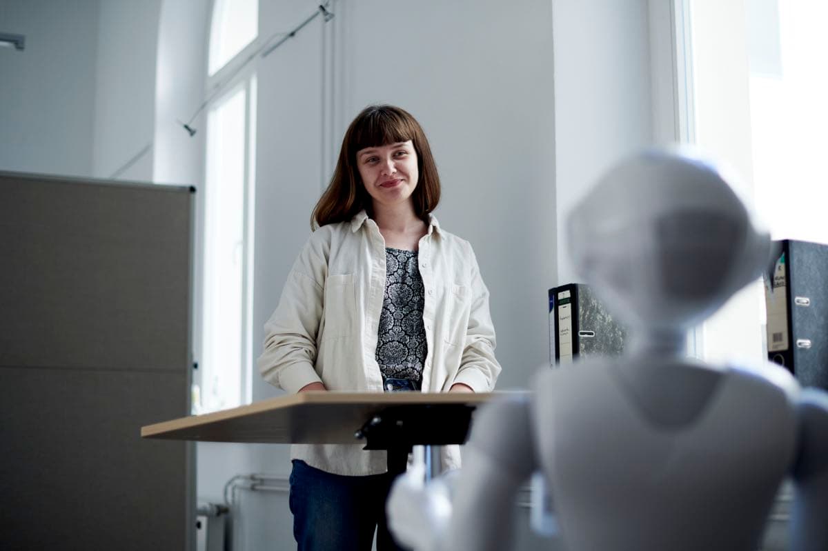 A person interacting with Pepper, the IWM robot