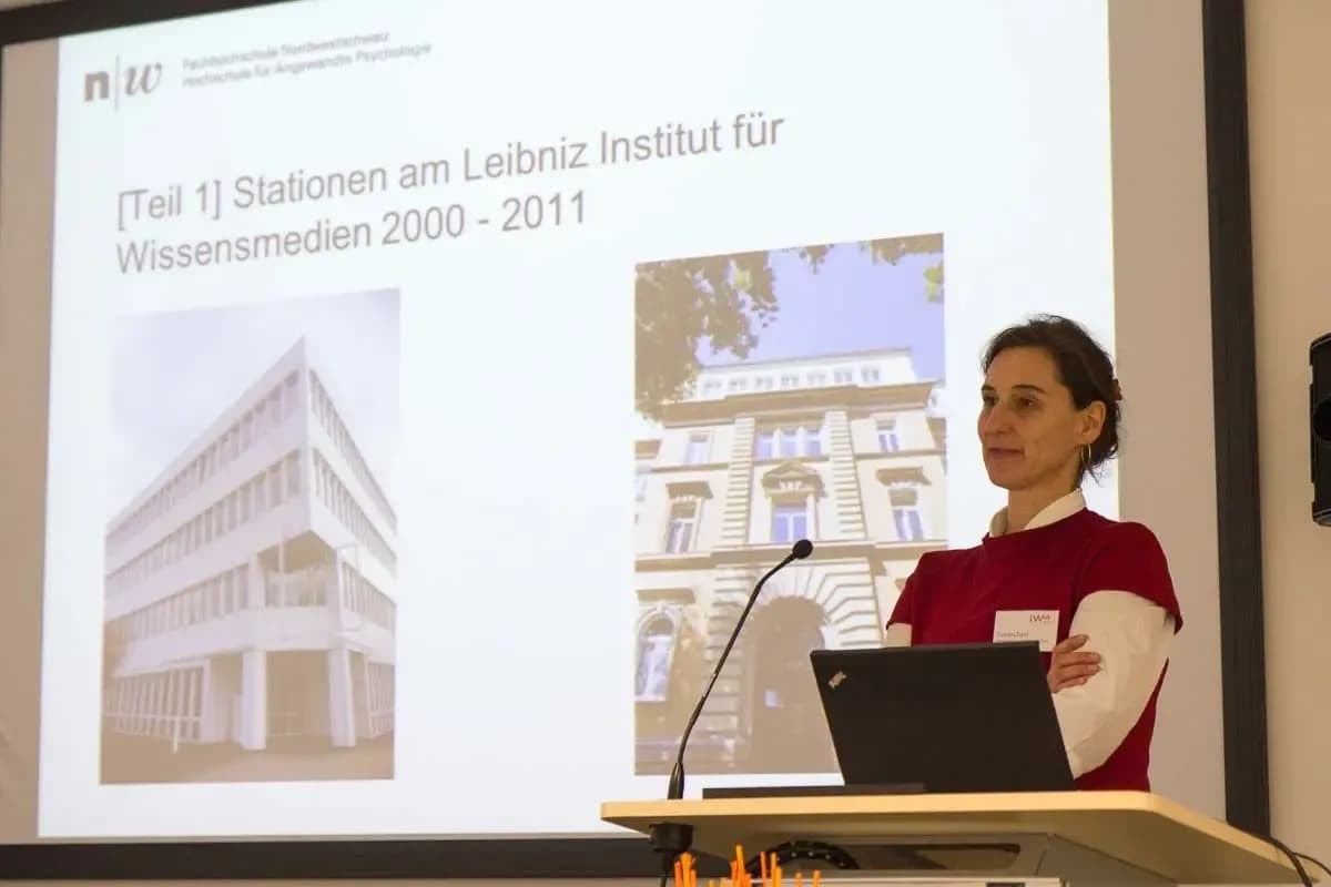 One person giving a talk at the alumni meeting of the IWM