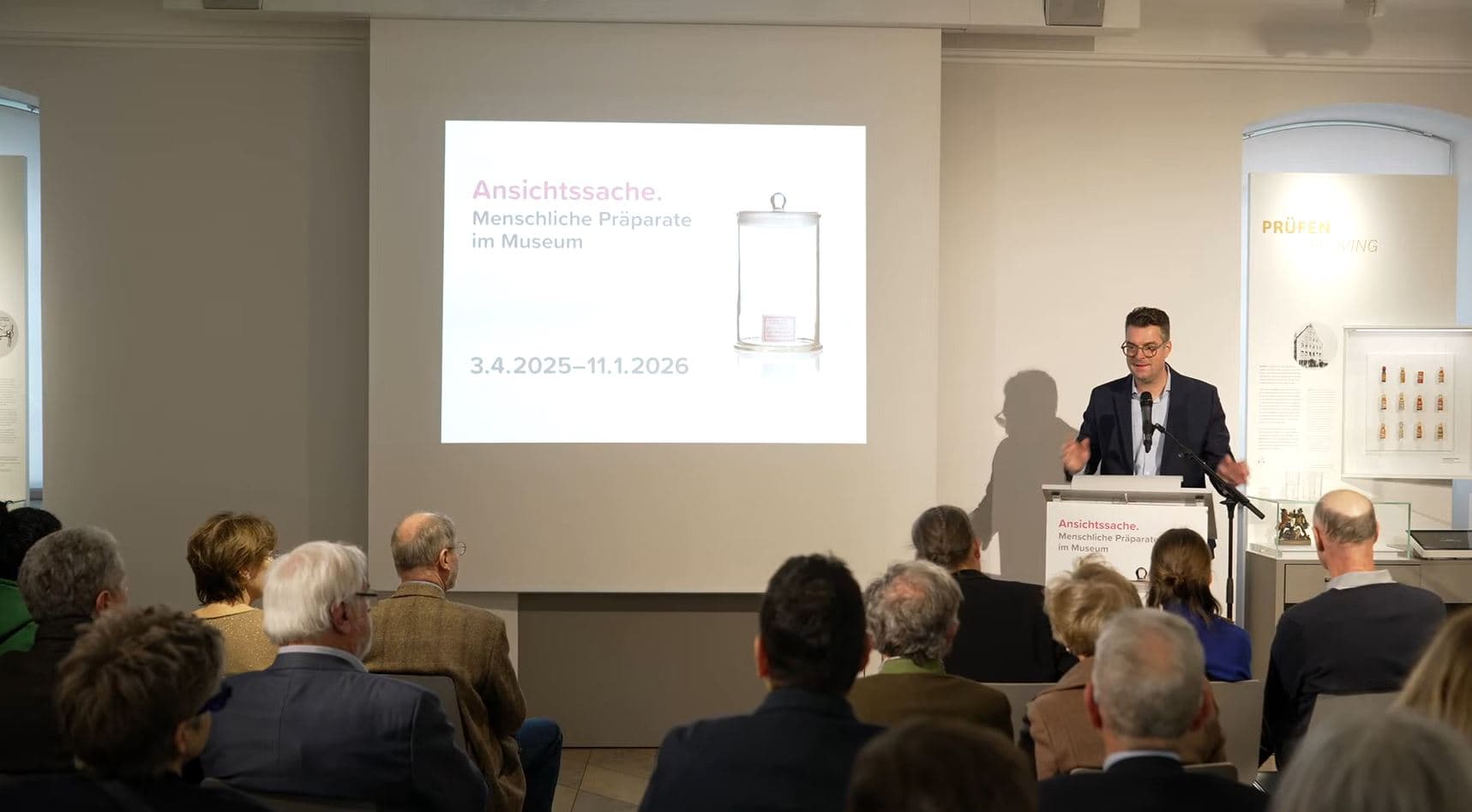 A man giving a speech at the opening exhibition